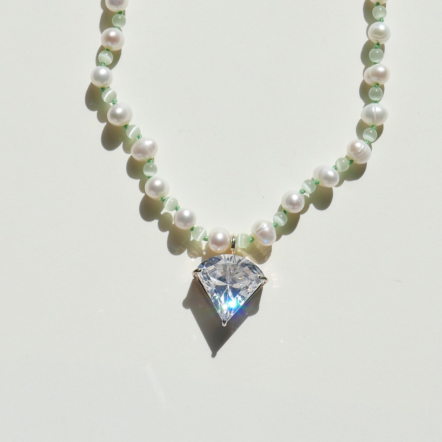 Light Green Necklace with a White Pendant