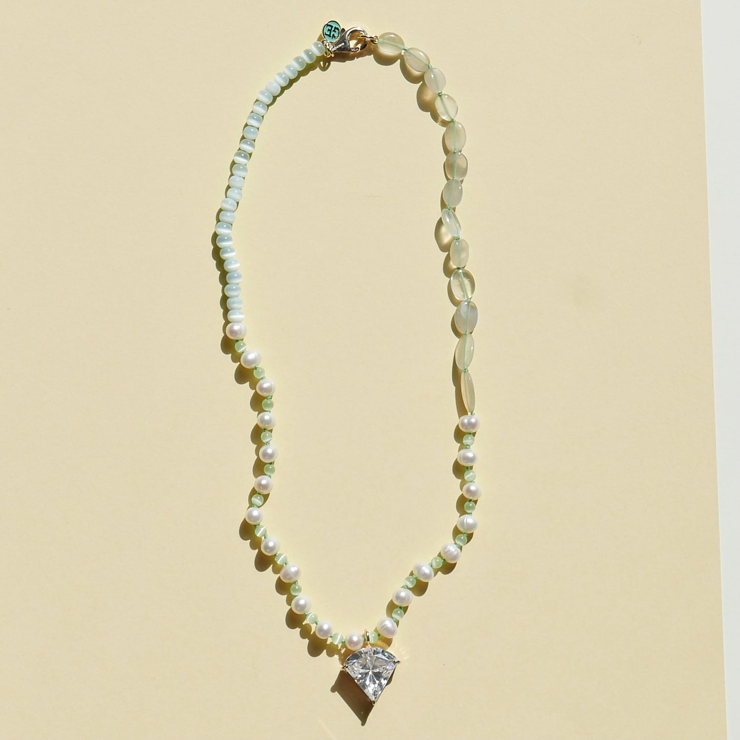 Light Green Necklace with a White Pendant